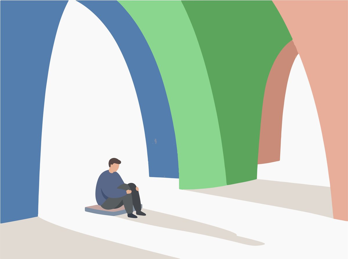 Man sitting alone under colorful arches